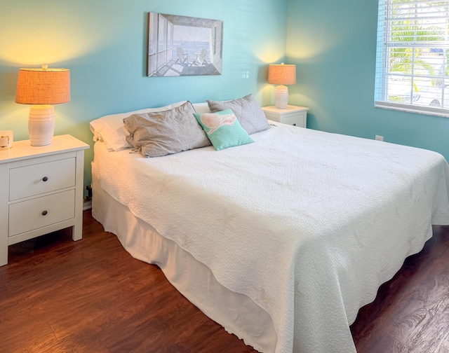 bedroom with dark wood-type flooring