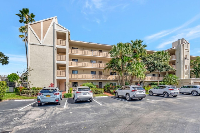 view of building exterior with uncovered parking