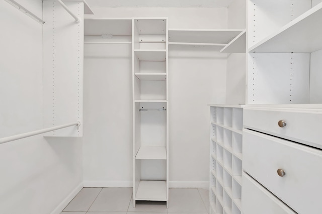 spacious closet with light tile patterned floors