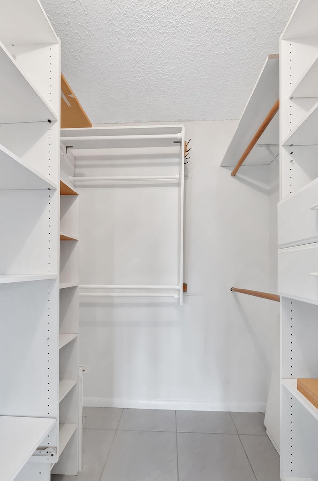 spacious closet featuring tile patterned floors