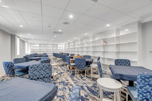 carpeted living room with recessed lighting, built in shelves, crown molding, and baseboards