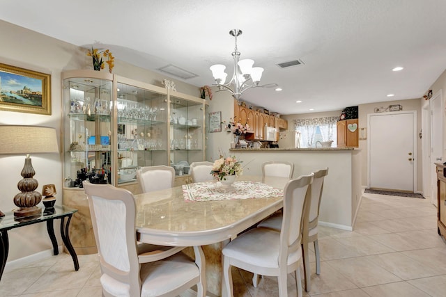 dining room featuring light tile patterned floors, recessed lighting, a notable chandelier, visible vents, and baseboards