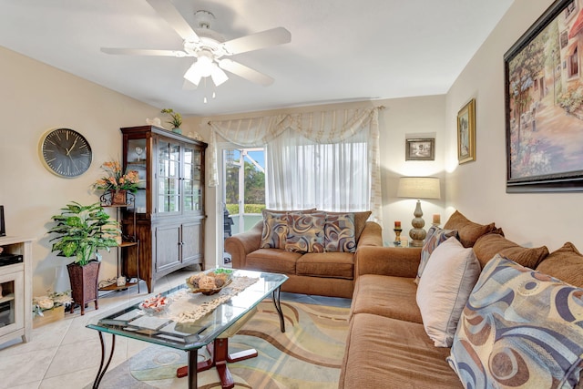 living area with a ceiling fan and light tile patterned floors