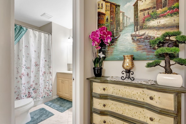 bathroom featuring tile patterned flooring, toilet, a shower with shower curtain, visible vents, and vanity