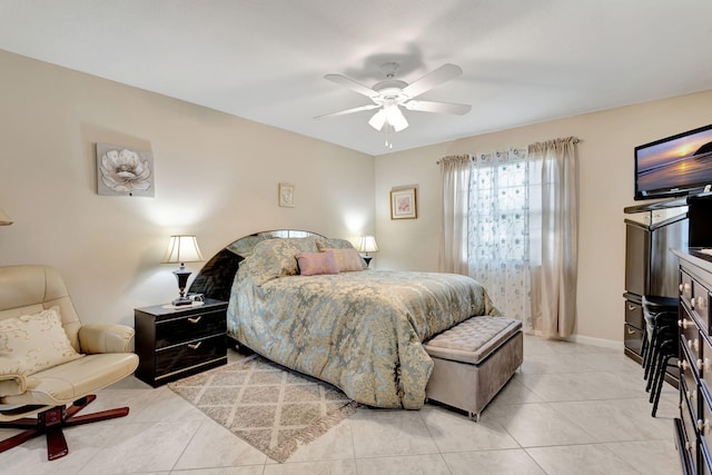 bedroom with light tile patterned floors, a ceiling fan, and baseboards