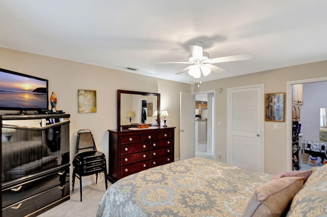 bedroom featuring ceiling fan, visible vents, and a closet