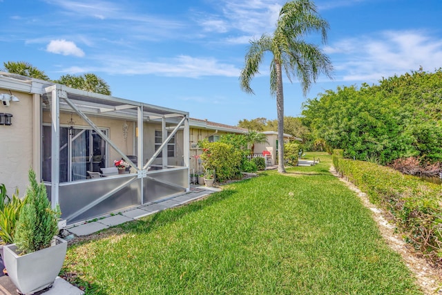 view of yard with a lanai