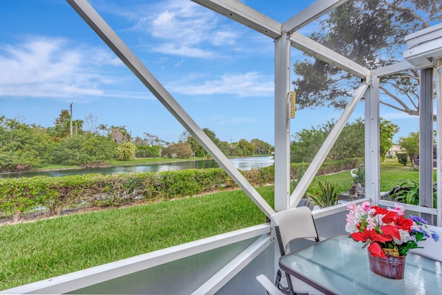 sunroom / solarium featuring a water view