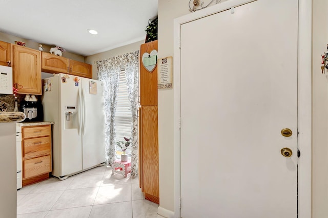 kitchen with white appliances and light tile patterned floors