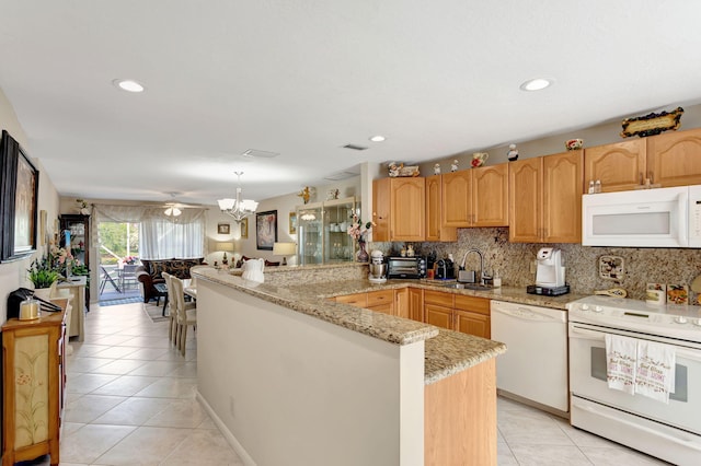 kitchen featuring white appliances, tasteful backsplash, a peninsula, a sink, and light tile patterned flooring