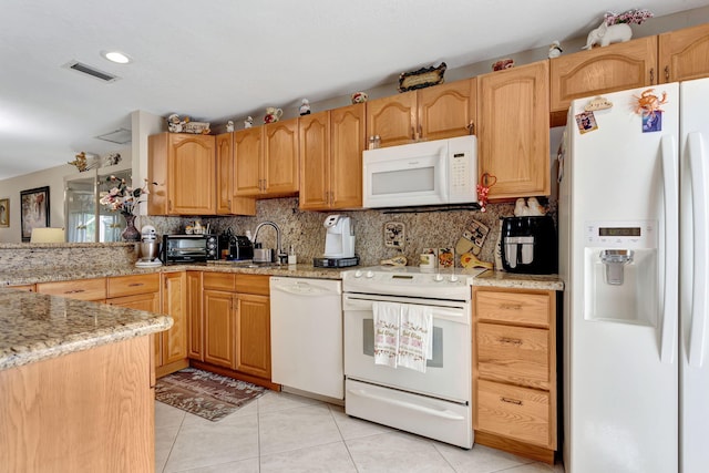 kitchen with white appliances, tasteful backsplash, light tile patterned floors, visible vents, and light stone counters