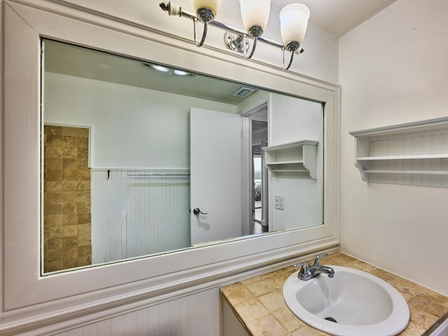 bathroom with wainscoting, visible vents, and vanity