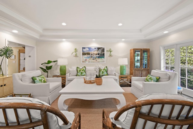 living room with recessed lighting, a tray ceiling, and crown molding