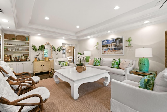 living room featuring visible vents, recessed lighting, crown molding, and a tray ceiling