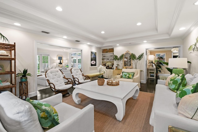 living area featuring visible vents, recessed lighting, wood finished floors, and ornamental molding