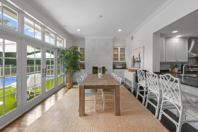 sunroom / solarium featuring french doors, visible vents, and a sink