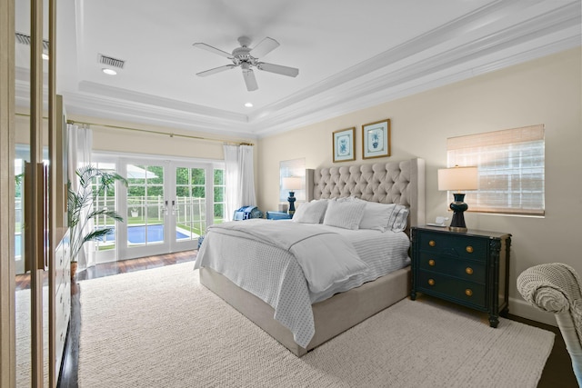 bedroom with visible vents, ornamental molding, french doors, a raised ceiling, and access to exterior