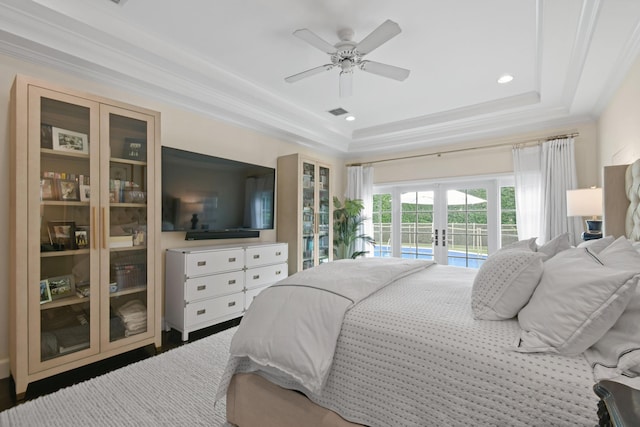 bedroom featuring ornamental molding, french doors, a tray ceiling, and access to outside