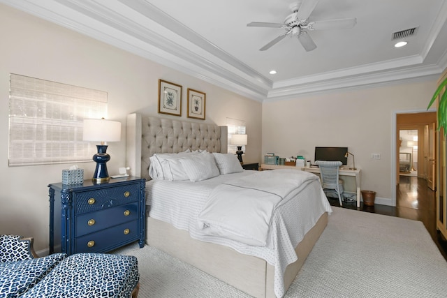 bedroom with a tray ceiling, visible vents, recessed lighting, and crown molding