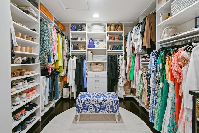 spacious closet with attic access and wood finished floors