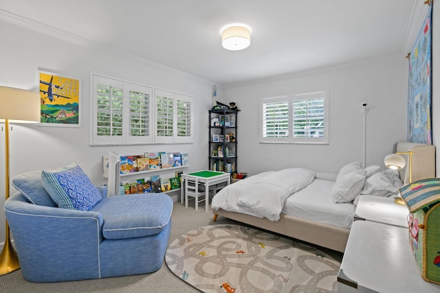 bedroom with ornamental molding and carpet flooring