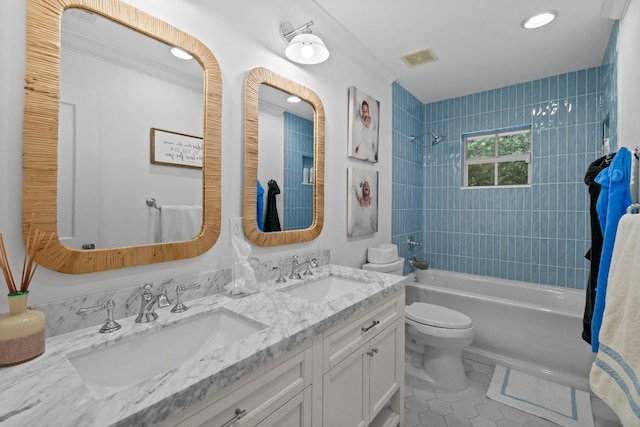 bathroom featuring tile patterned floors, toilet, washtub / shower combination, and a sink