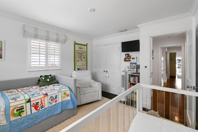 bedroom featuring visible vents, a closet, and ornamental molding