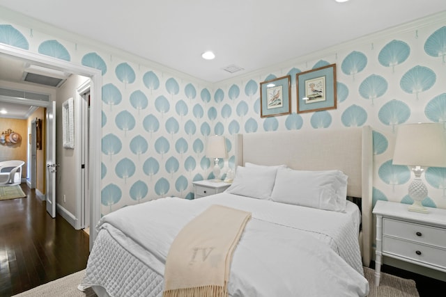 bedroom featuring ornamental molding, dark wood finished floors, wallpapered walls, baseboards, and attic access