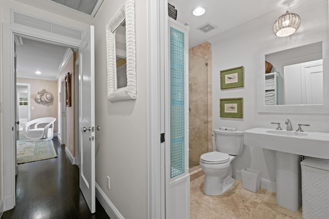 bathroom featuring baseboards, toilet, and crown molding