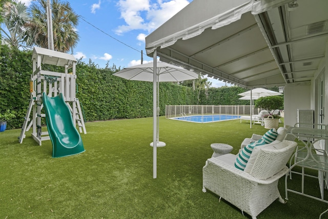 exterior space with a playground, a fenced in pool, and fence