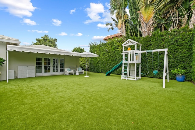 view of yard with french doors and a playground