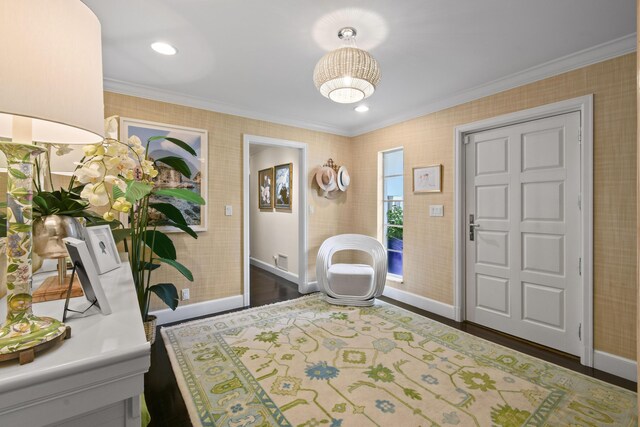 entrance foyer with wallpapered walls and ornamental molding