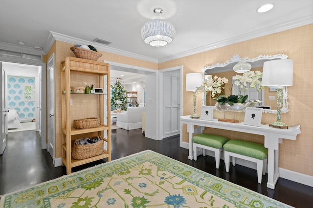 bedroom featuring visible vents, wallpapered walls, baseboards, dark wood finished floors, and ornamental molding