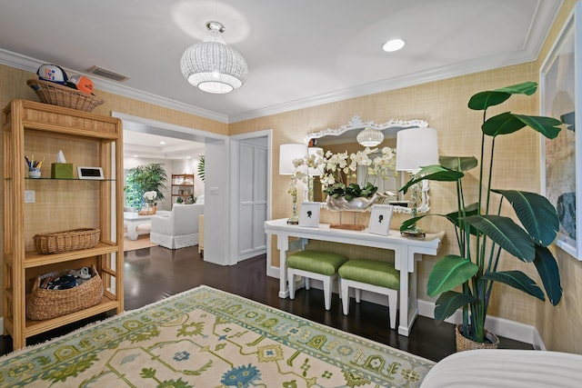 bedroom with visible vents, wood finished floors, crown molding, wallpapered walls, and baseboards