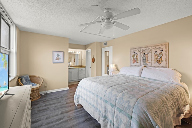 bedroom featuring visible vents, dark wood-type flooring, ceiling fan, a textured ceiling, and baseboards