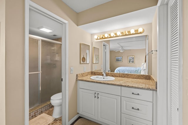 full bathroom with a stall shower, a closet, vanity, and ensuite bathroom