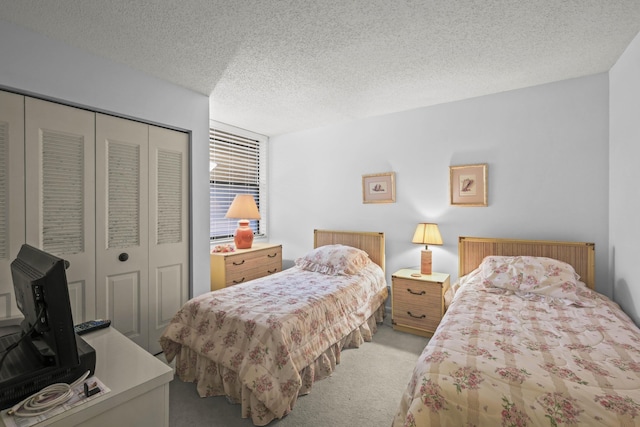 bedroom featuring carpet, a textured ceiling, and a closet