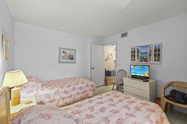 bedroom with a textured ceiling, visible vents, and carpet flooring