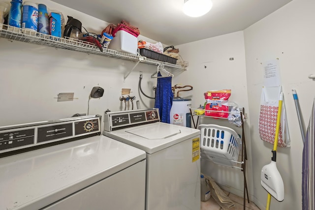 laundry area featuring laundry area, water heater, and washer and dryer