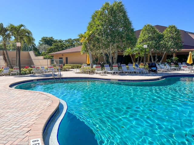 pool featuring a patio area and fence