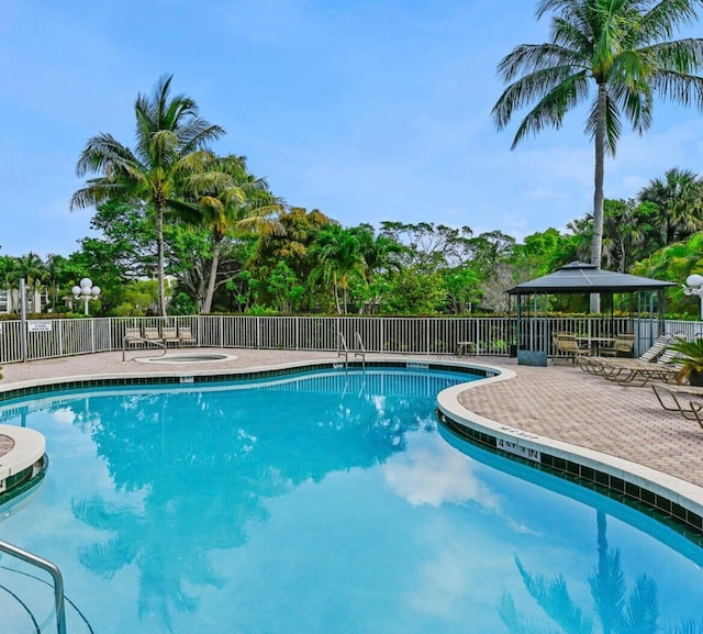 pool with fence and a patio