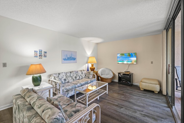 living area with a textured ceiling, baseboards, and wood finished floors