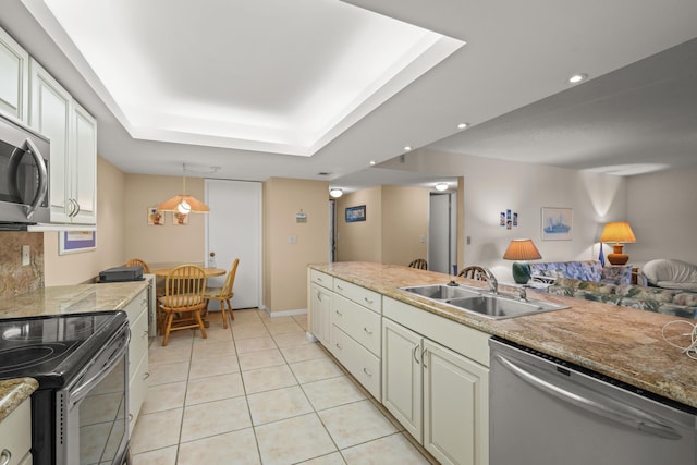 kitchen featuring light tile patterned flooring, recessed lighting, stainless steel appliances, a sink, and a raised ceiling