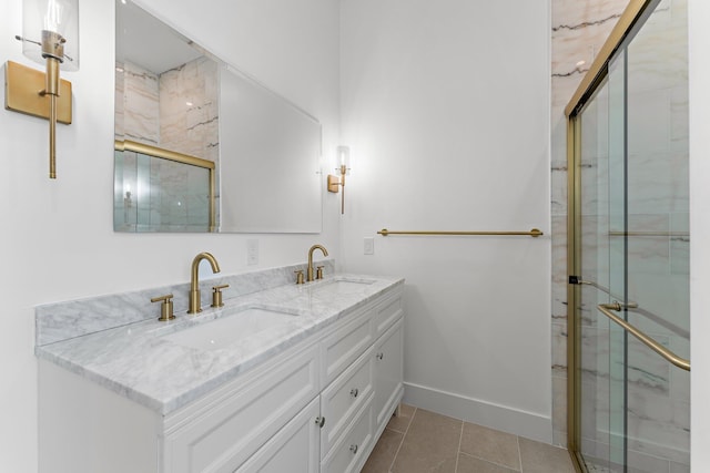 full bathroom with a stall shower, tile patterned flooring, a sink, and baseboards