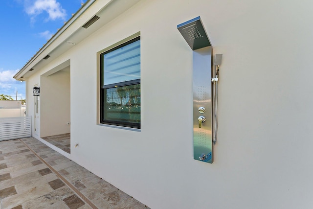 view of side of property with stucco siding