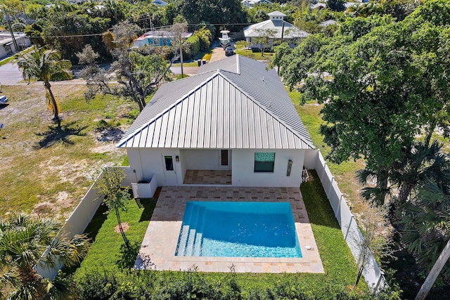 pool with a patio, a lawn, and a fenced backyard