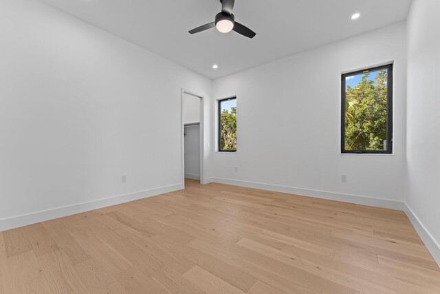 empty room with a ceiling fan, recessed lighting, baseboards, and light wood finished floors