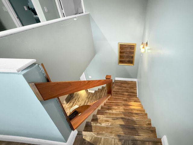 stairs featuring wood finished floors