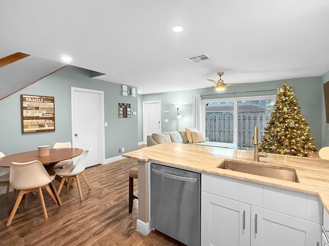 kitchen featuring a ceiling fan, wood finished floors, a sink, white cabinets, and dishwasher