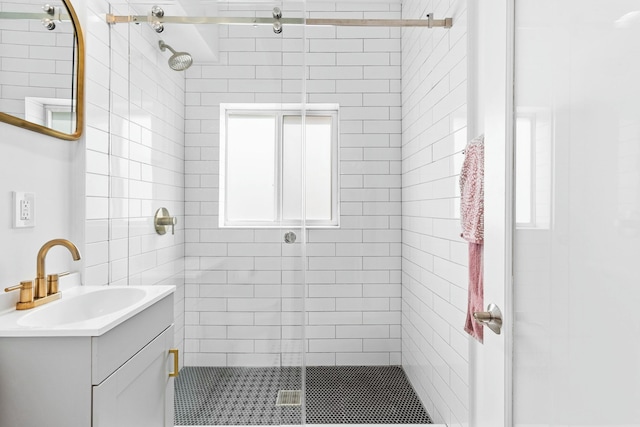 full bath with a stall shower and vanity